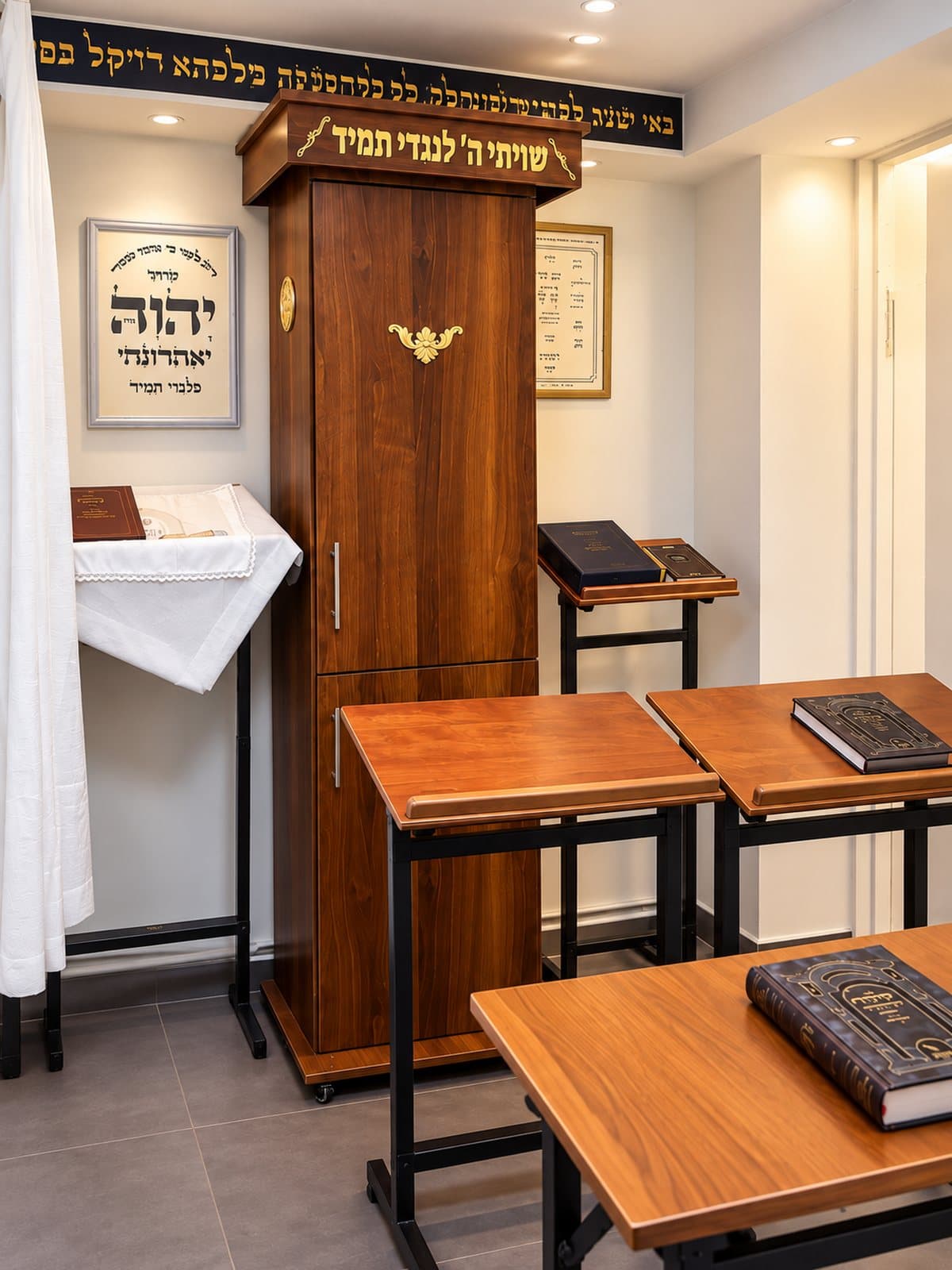 Inside the Beis Medrash: the aron kodesh, shtenders and wooden learning tables